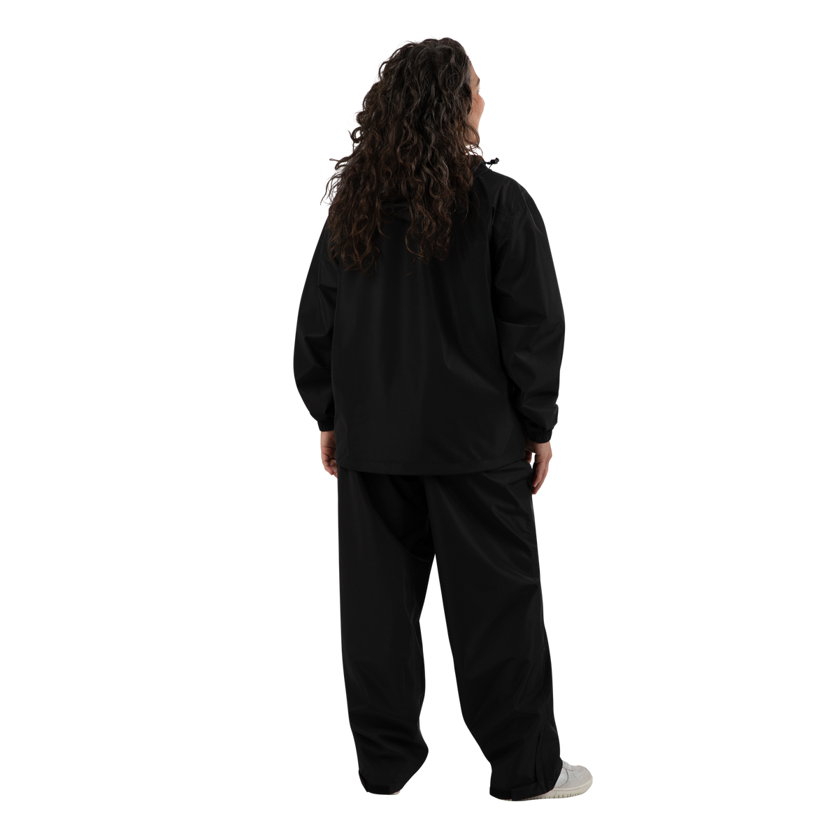 A person shown from the back wearing a black long-sleeve top and matching black pants, standing against a plain white background.