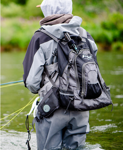 Image of man fly fishing wearing frogg toggs fishing gear and a frogg toggs backpack