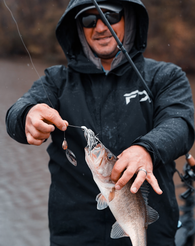 Keith Poche presenting a freshly caught fish. Keith’s favorite frogg toggs gear is the frogg toggs Co-Pilot Jacket.