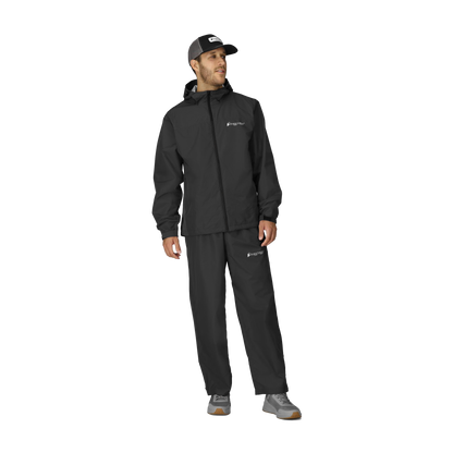Man wearing a black raincoat and pants with a cap on a white background