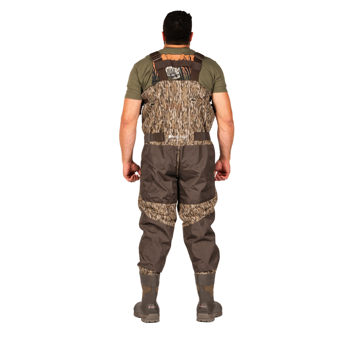 A man viewed from the back wearing a pair of brown and camouflage waders over an olive green shirt, standing against a solid white background.