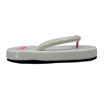 White sandal with pink accents on a white background