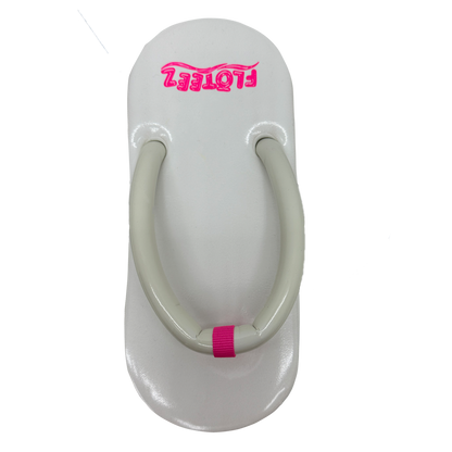 White sandal with pink accents on a white background