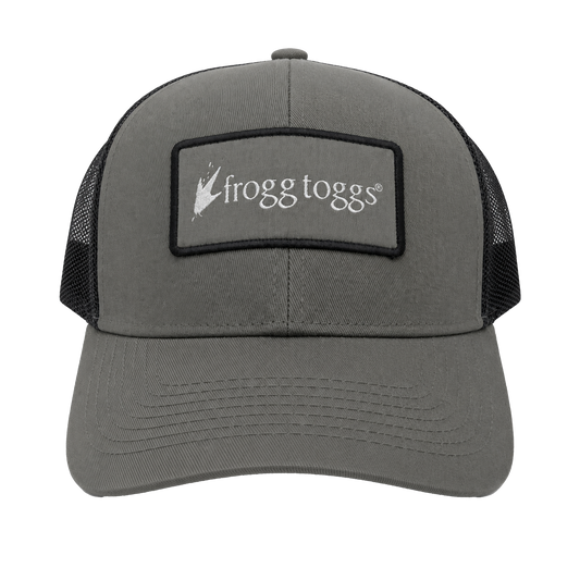 A gray Frogg Togg trucker hat with black mesh side panels and a black rectangular patch on the front featuring the white 'frogg toggs' logo.