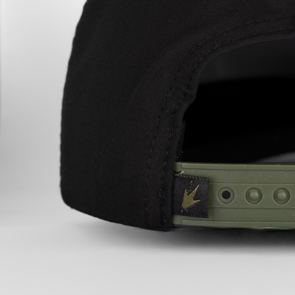Close-up of a black cap with a brand logo on a white background