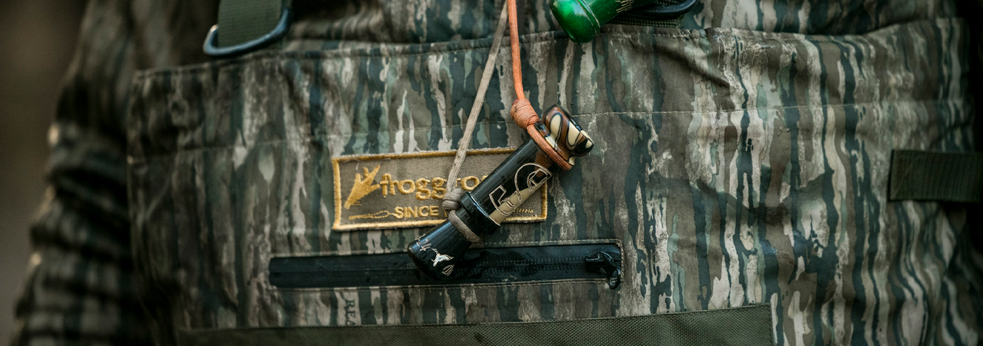 Camouflage hunting vest with a brand logo on a blurred background