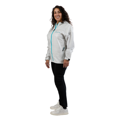A woman modeling a light gray hooded windbreaker jacket with a bright turquoise zipper, paired with black pants and white sneakers, shown against a solid white background.