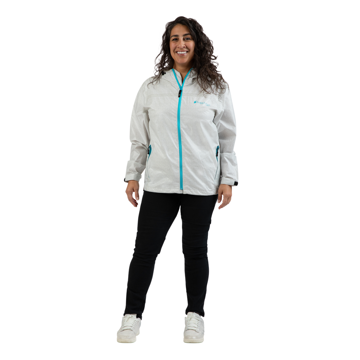 A woman modeling a light gray waterproof jacket with a bright turquoise zipper and logo, paired with black pants and white sneakers, against a plain white background.