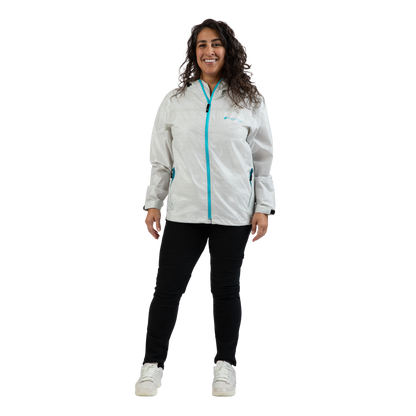 A woman modeling a light gray waterproof jacket with a bright turquoise zipper and logo, paired with black pants and white sneakers, against a plain white background.