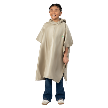 Child wearing a beige rain poncho on a white background