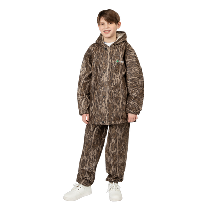 Child wearing a camouflage rain suit on a white background