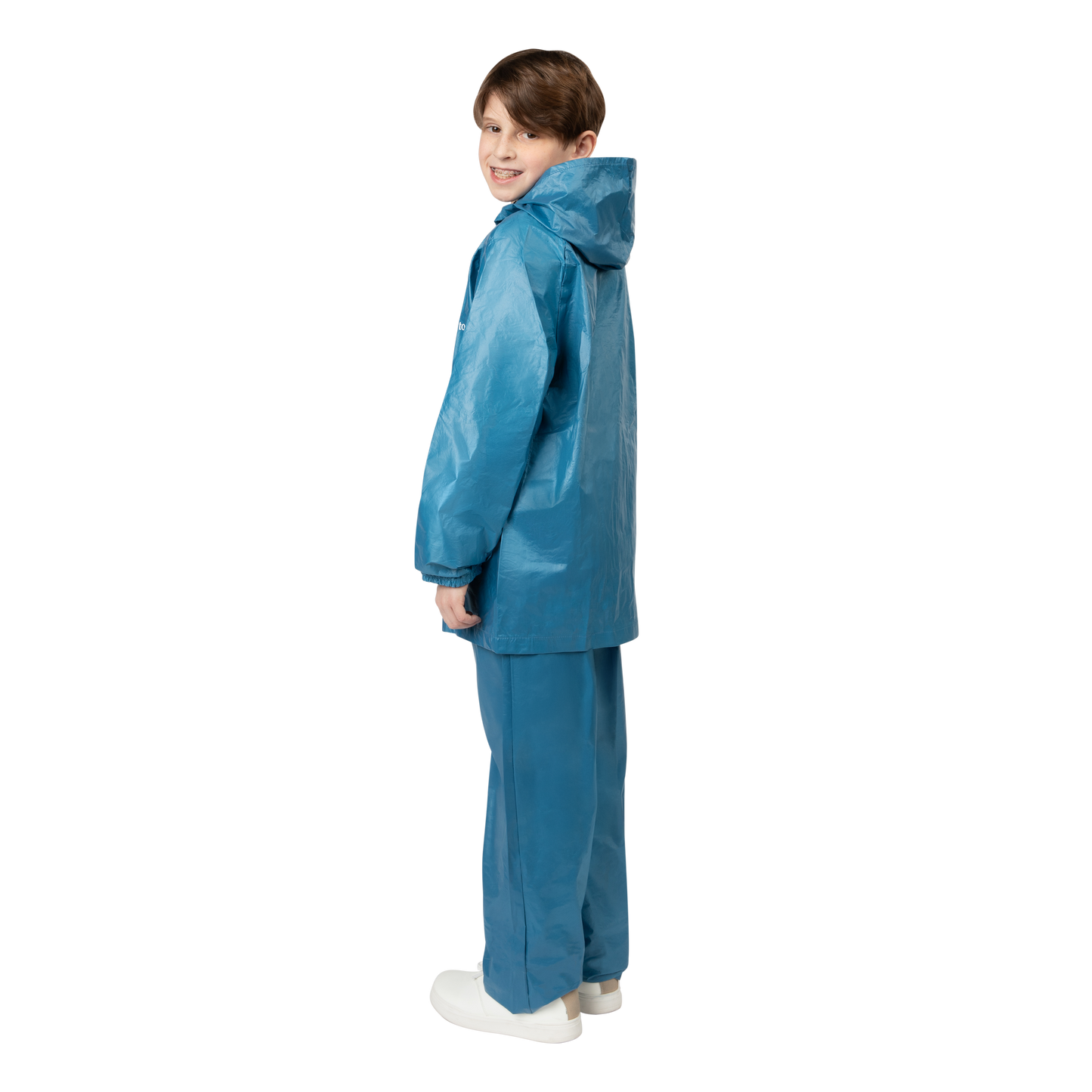 Child wearing a blue raincoat and pants on a white background