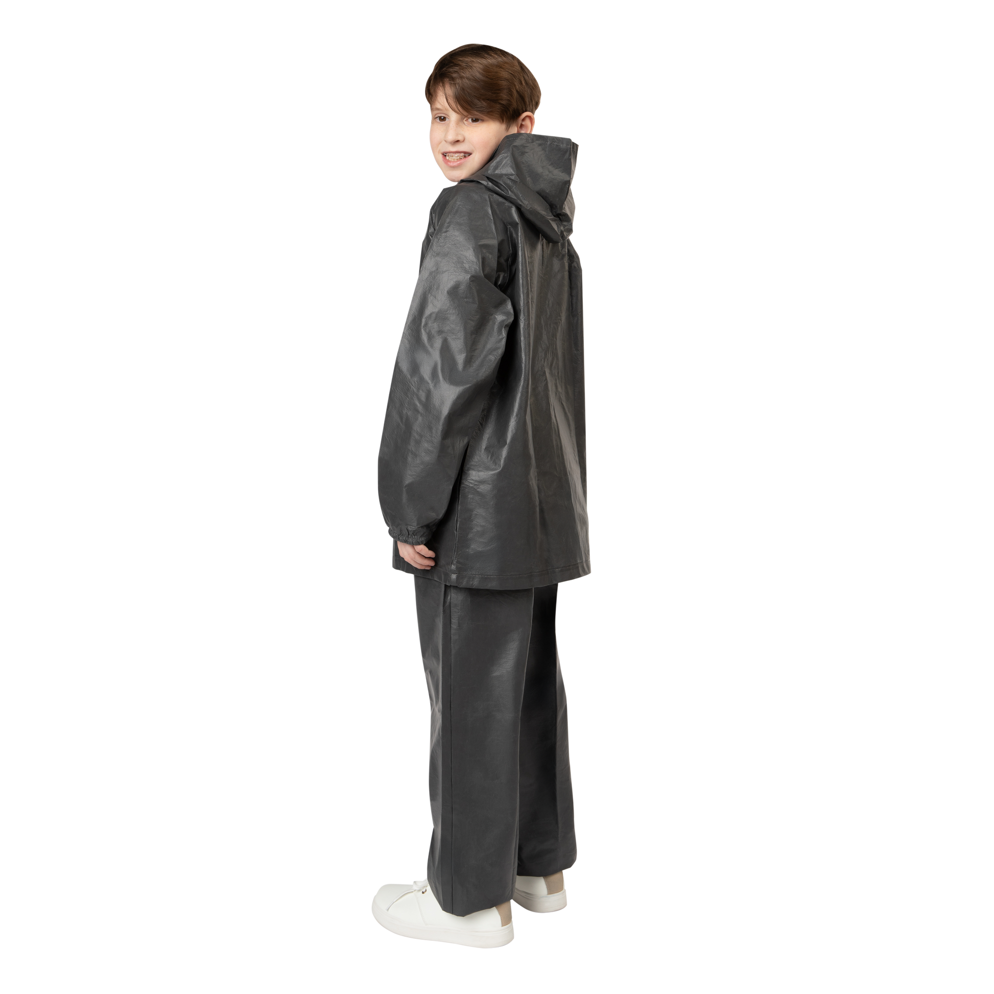 Child wearing a black raincoat and pants on a white background